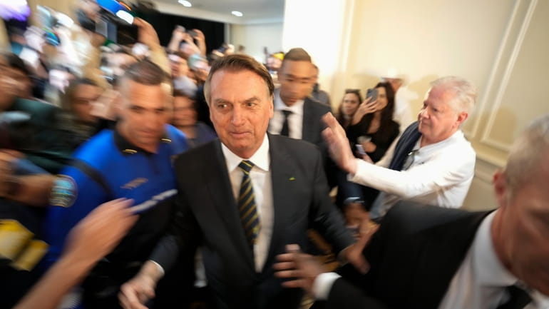 Brazil's former President Jair Bolsonaro leaves after attending an event...