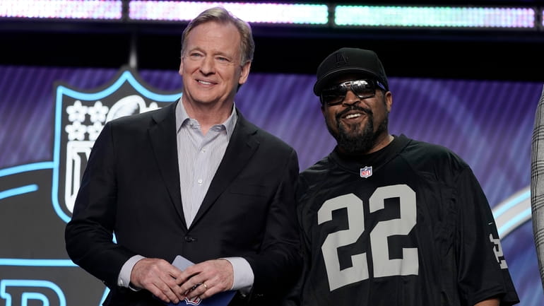 FILE - Rapper Ice Cube, right, poses with NFL Commissioner...