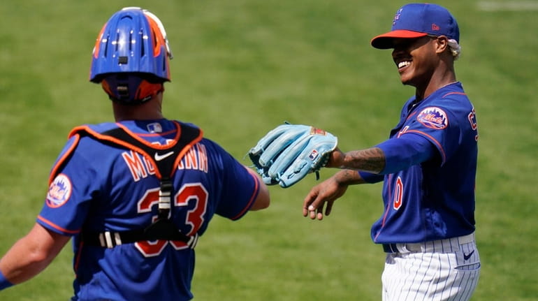 Mets pitcher Marcus Stroman is congratulated by catcher James McCann...