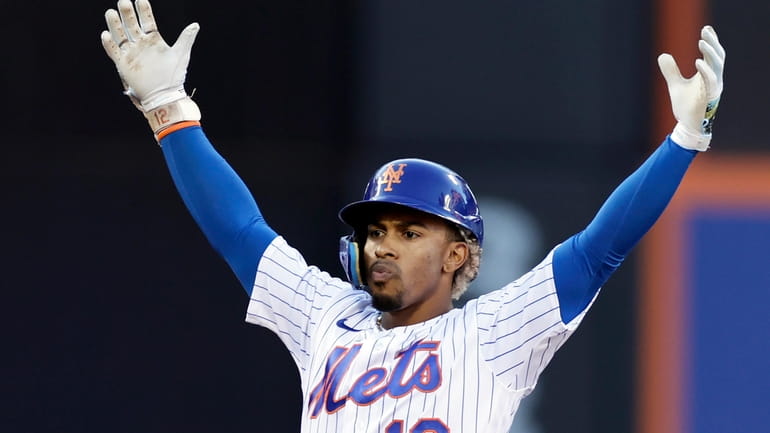 New York Mets' Francisco Lindor reacts after hitting an RBI...