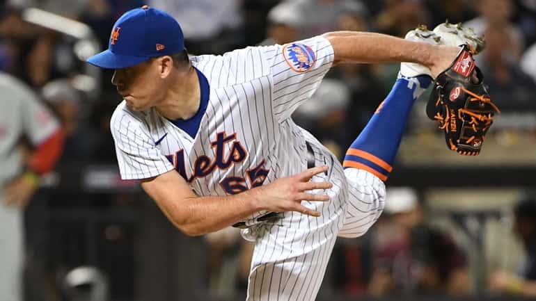 New York Mets relief pitcher Trevor May delivers against the...