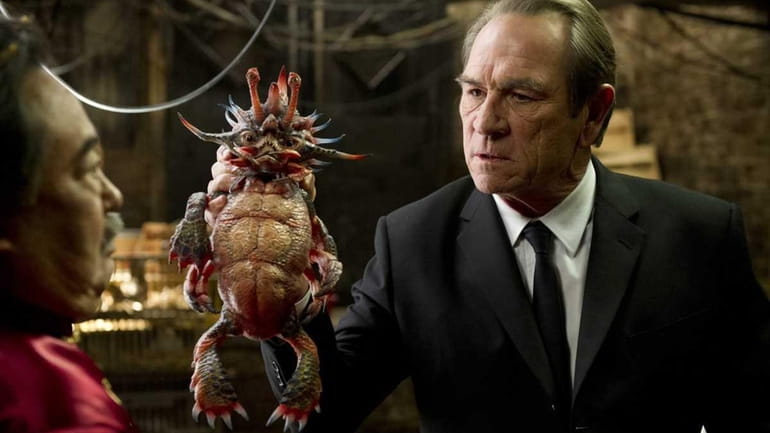 Keone Young, left, and Tommy Lee Jones holding "Spiky Bulba"...