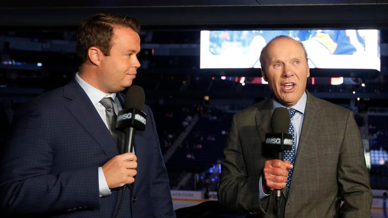 New York Islanders broadcasters Brendan Burke, left, and Butch Goring work...