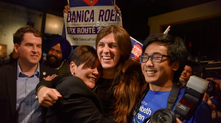 Danica Roem of Virginia, center, is the first openly transgender...