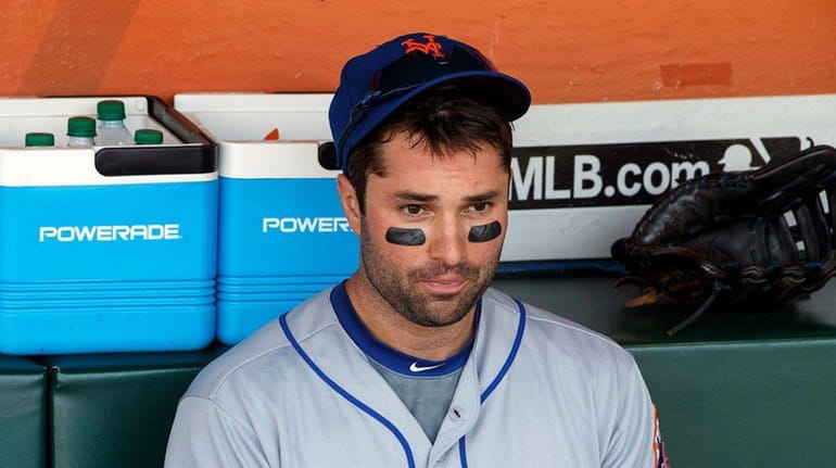 Neil Walker of the Mets sits in the dugout before...