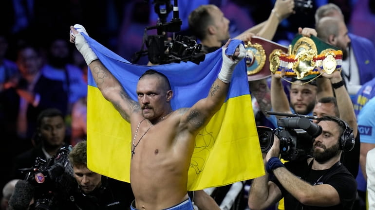 FILE - Ukraine's Oleksandr Usyk celebrates after beating Britain's Anthony...