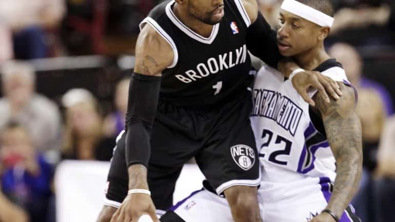 Brooklyn Nets guard C.J. Watson protects the ball from Sacramento...