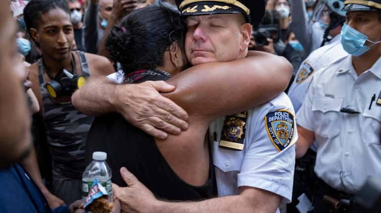 NYPD Chief of Department Terence Monahan hugs a protester Monday...