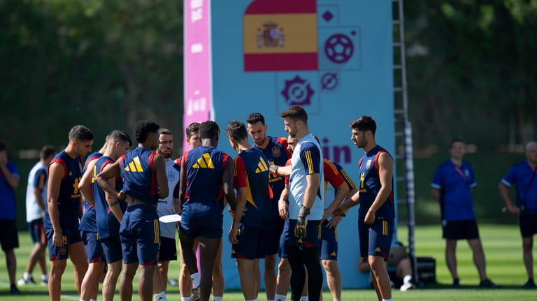 Spain players huddle during a training session at Qatar University,...