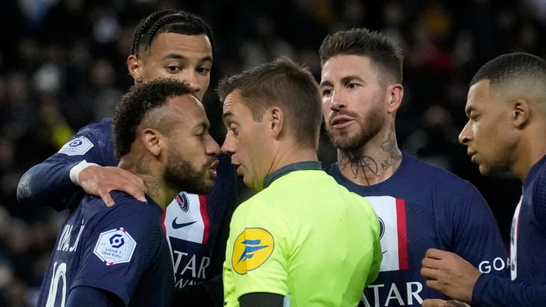 PSG's Neymar, front left, discusses with Referee Clement Turpin after...