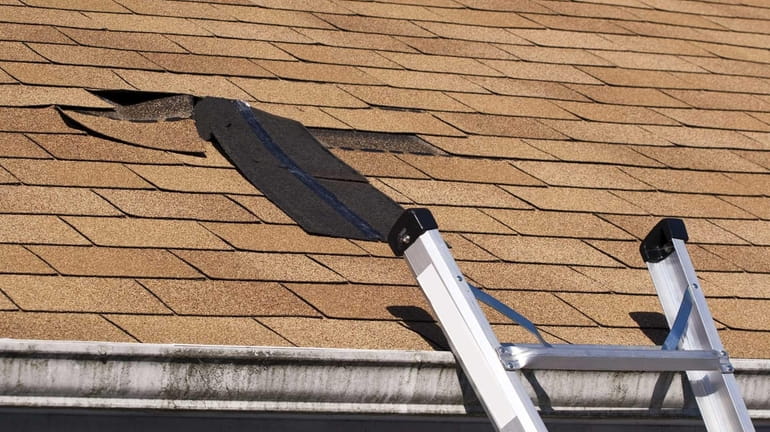 Fixing damaged roof shingles, shown here is a section that...