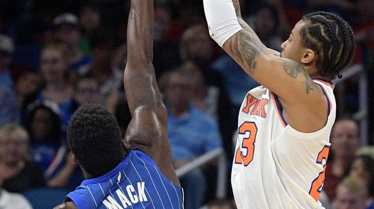 Knicks guard Trey Burke goes up for a shot in...
