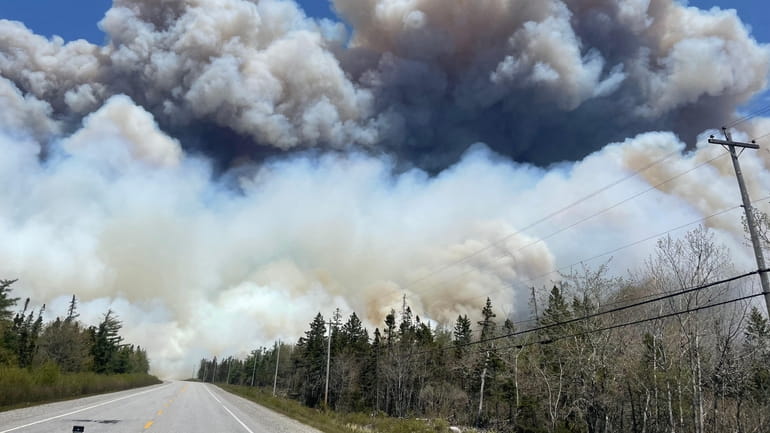 Smoke rises this week from a wildfire near Barrington Lake...