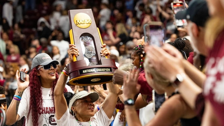 South Carolina basketball coach Dawn Staley carries the NCAA college...