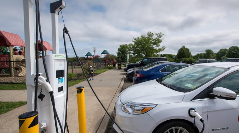 An electric vehicle charging station at Heritage Park in Mount Sinai. When...