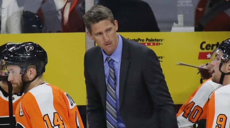 Kris Knoblauch, assistant coach of the Philadelphia Flyers, handles bench...