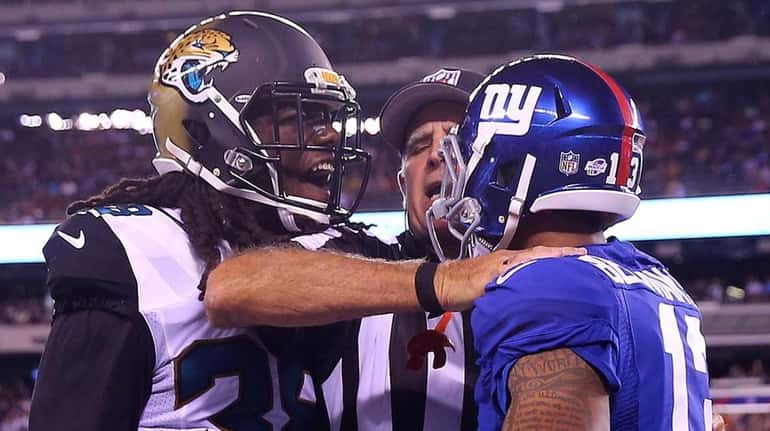 Sergio Brown #38 of the Jacksonville Jaguars and Odell Beckham...