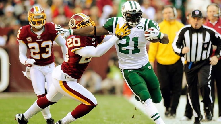 Oshiomogho Atogwe of the Washington Redskins tackles LaDainian Tomlinson of...
