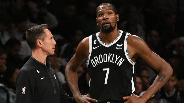 Brooklyn Nets forward Kevin Durant stands with head coach Steve...