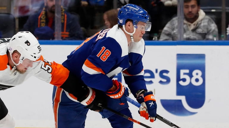 Anthony Beauvillier of the Islanders skates against Rasmus Ristolainen of the...