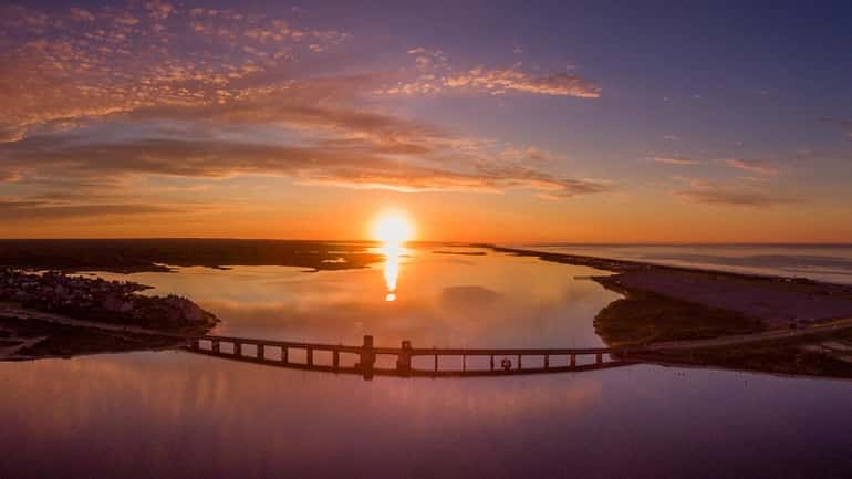 A drone catches the sunrise at Smith Point Bridge at...