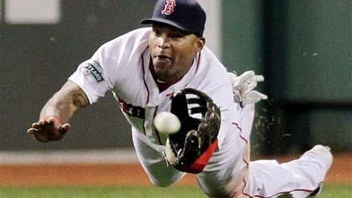 Boston Red Sox center fielder Marlon Byrd dives to catch...