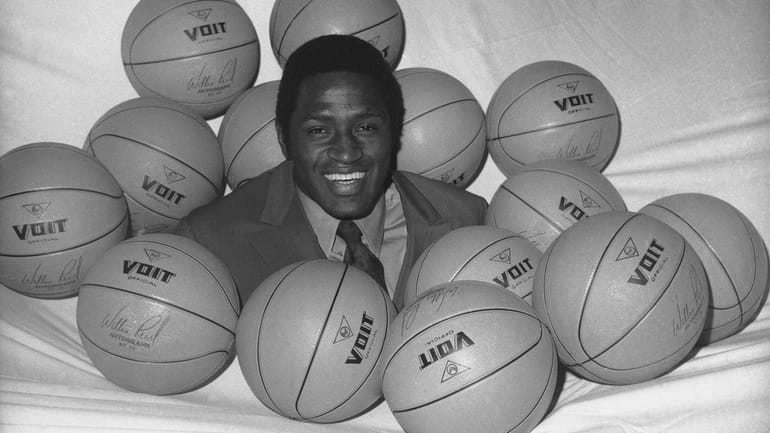 The Knicks' Willis Reed is surrounded by basketballs on May 14,...