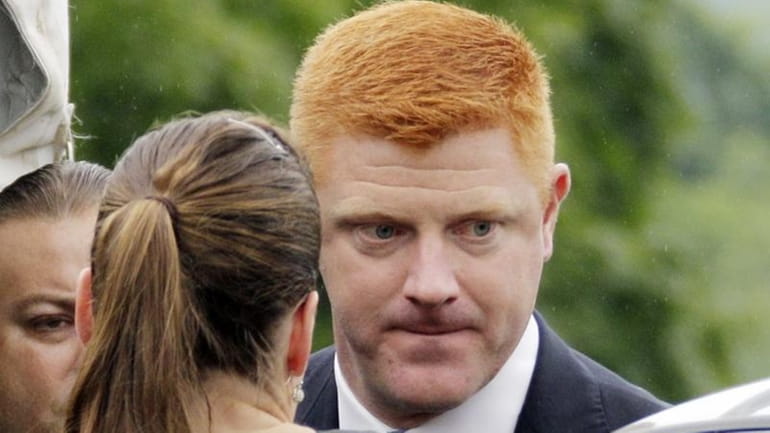 Penn State University assistant football coach Mike McQueary arrives at...