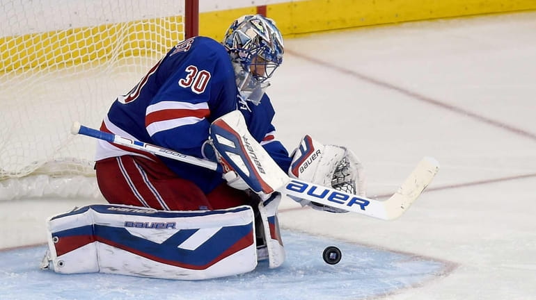 The New York Rangers' Henrik Lundqvist makes a save during...