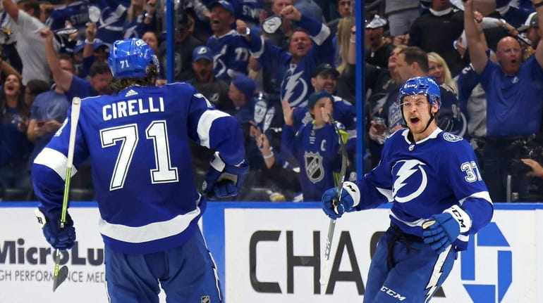 Yanni Gourde #37 of the Tampa Bay Lightning is congratulated...