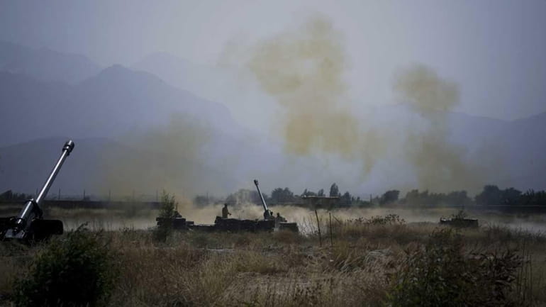 Pakistani troops fire heavy artillery toward alleged militants hideouts in...