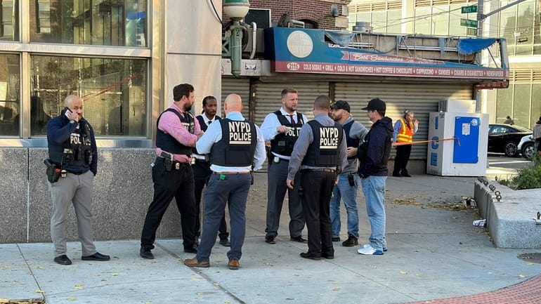 NYPD detectives search for an assailant who shot and killed a...