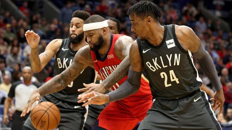 The Pelicans' DeMarcus Cousins fights for a rebound with the...