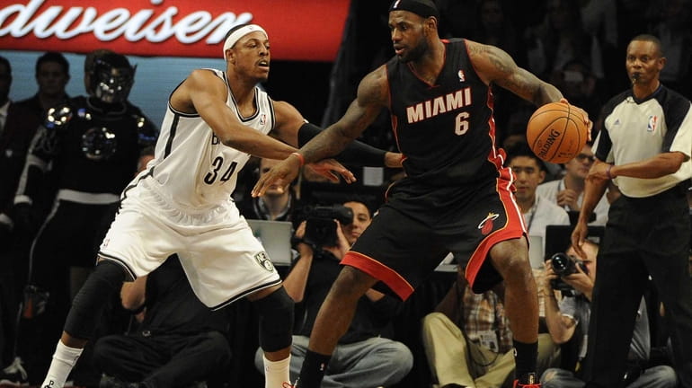 Nets' Paul Pierce guards Miami Heat's LeBron James during the...