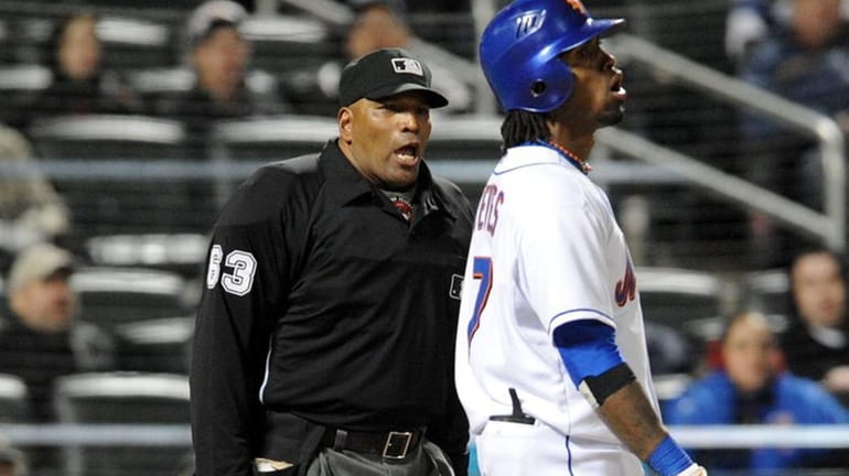 Mets shortstop Jose Reyes reacts after he was called out...