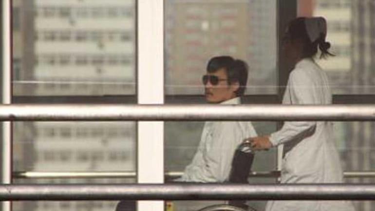 Chinese activist activist Chen Guangcheng (L) is seen in a...