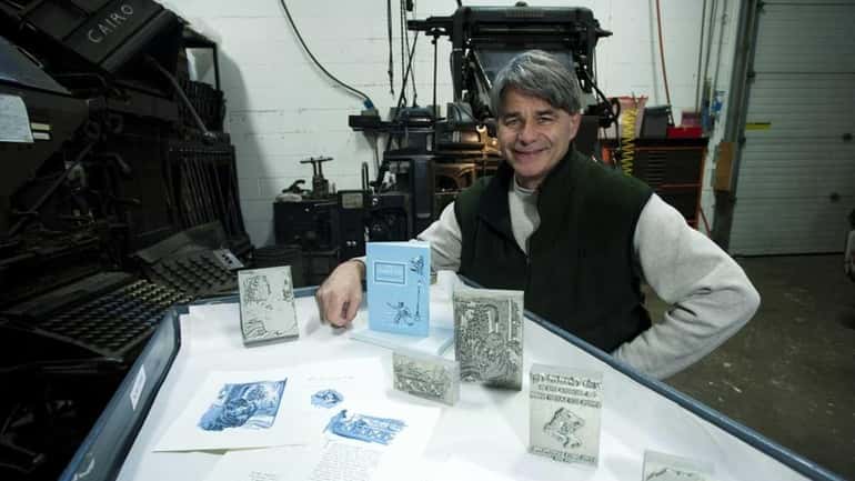 Tom Glazer, president of Graphic Image of Melville, shows printed...