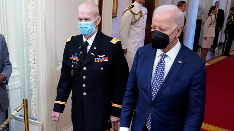 President Joe Biden arrives with Capt. Larry Taylor, an Army...
