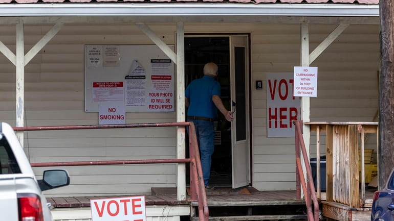 A voter enters Tuscaloosa County Ward 5, Montgomery Fire Department,...