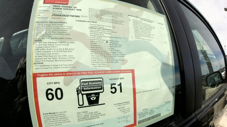 The window sticker displays the mileage ratings for an unsold...