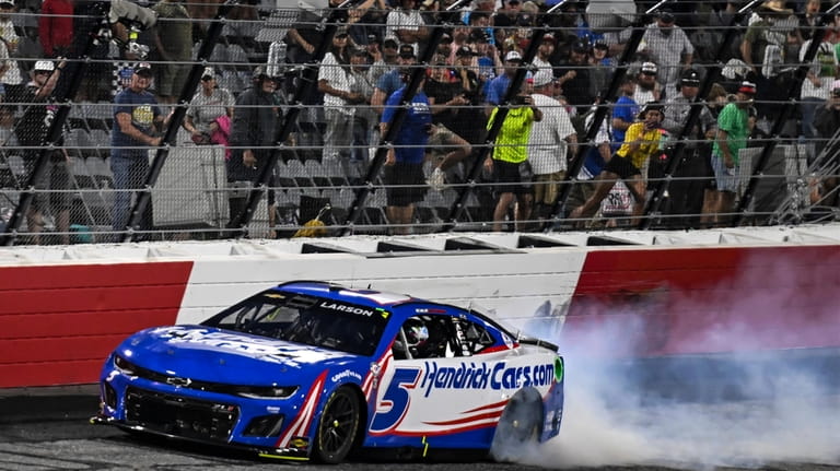 Kyle Larson (5) does a burnout after winning the NASCAR...