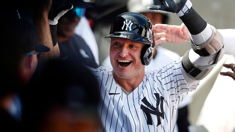 Yankees third baseman Josh Donaldson celebrates in the dugout after...