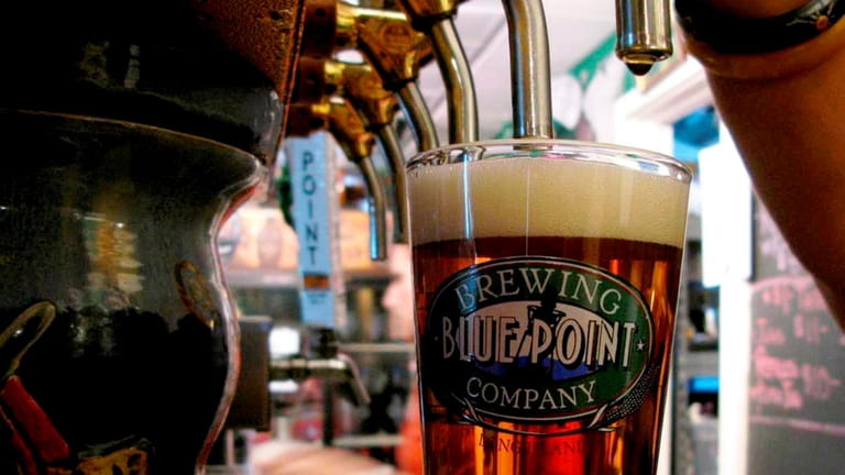 A pint of Blue Point Brewing Company beer is poured. 