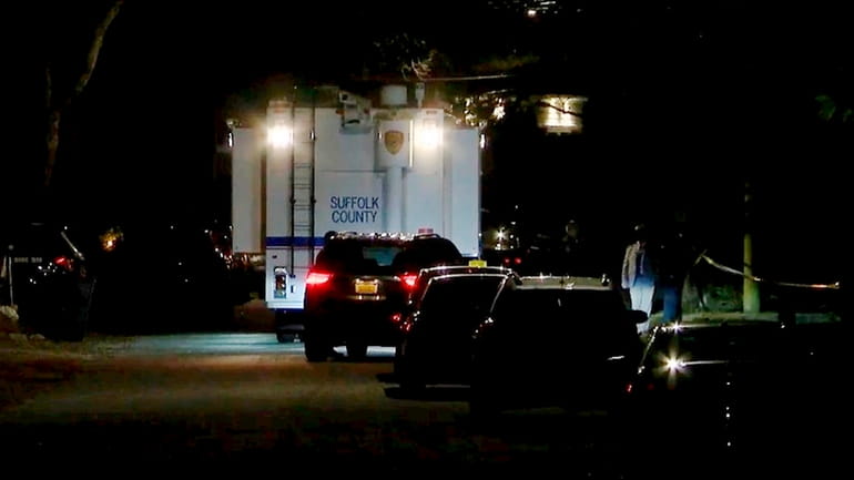 Suffolk County police detectives at the scene of the shooting...