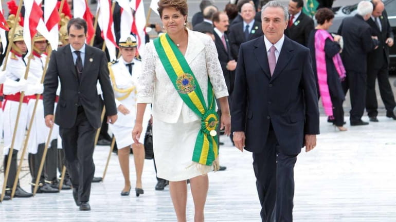 Wearing the green-and-gold presidential sash, newly-elected Brazilian President Dilma Rousseff...