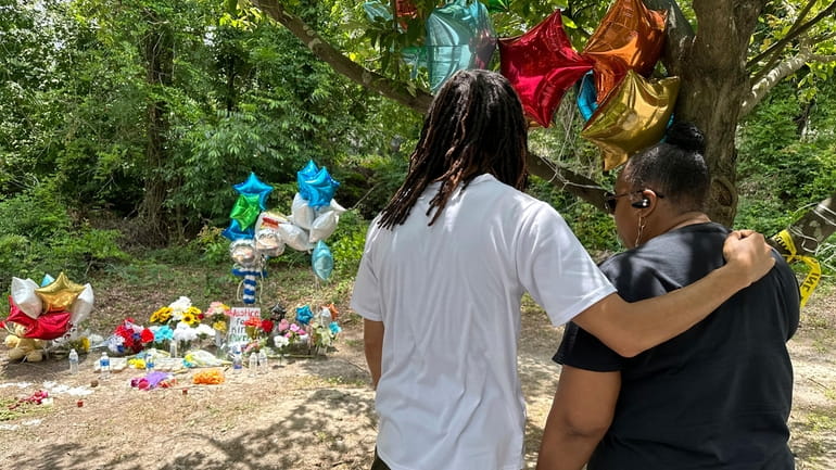 Mourners stop by a memorial to Cyrus Carmack-Belton on Thursday,...