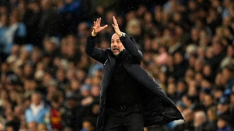 Manchester City's head coach Pep Guardiola gives instructions during the...