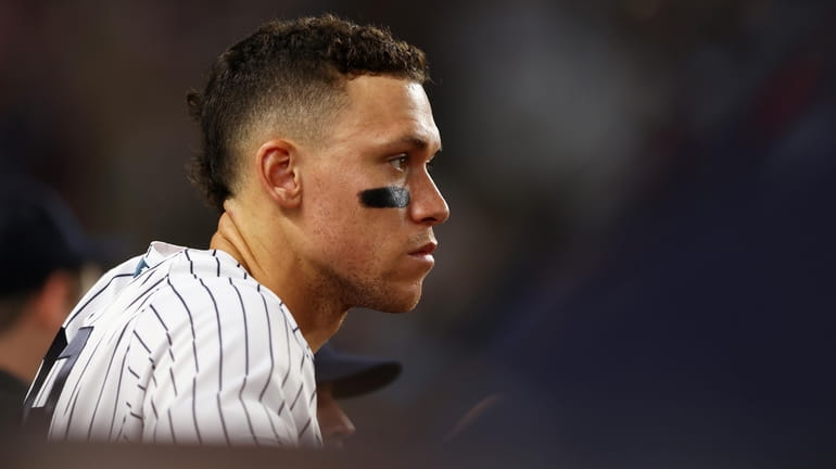Aaron Judge of the Yankees looks on from the bench in the...