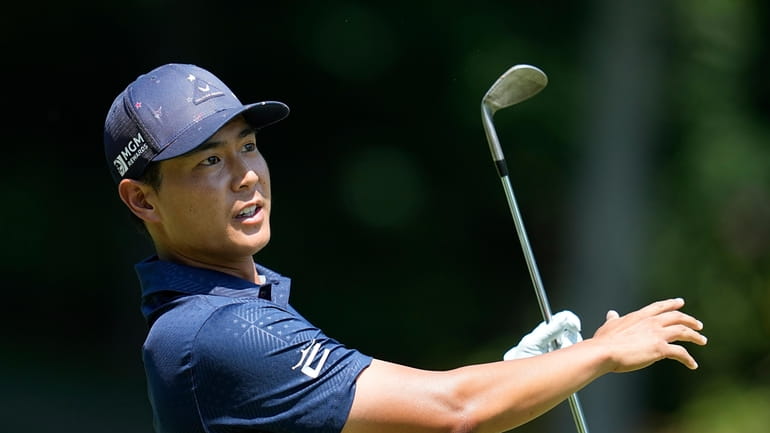 Justin Suh watches his shot on the ninth hole during...