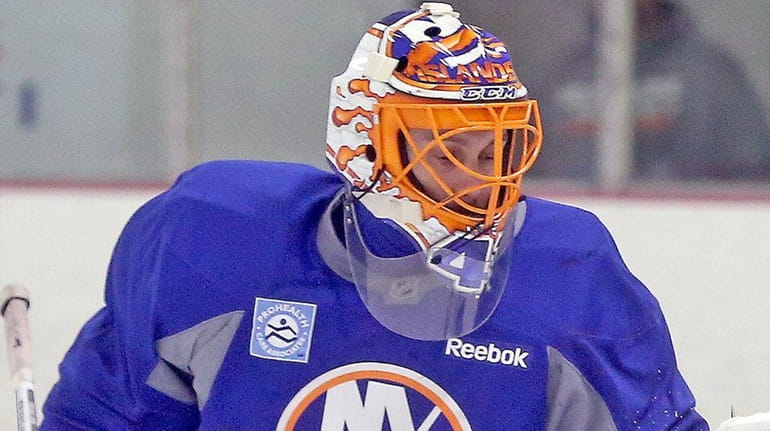 Jaroslav Halak gets a glove on the puck at the...